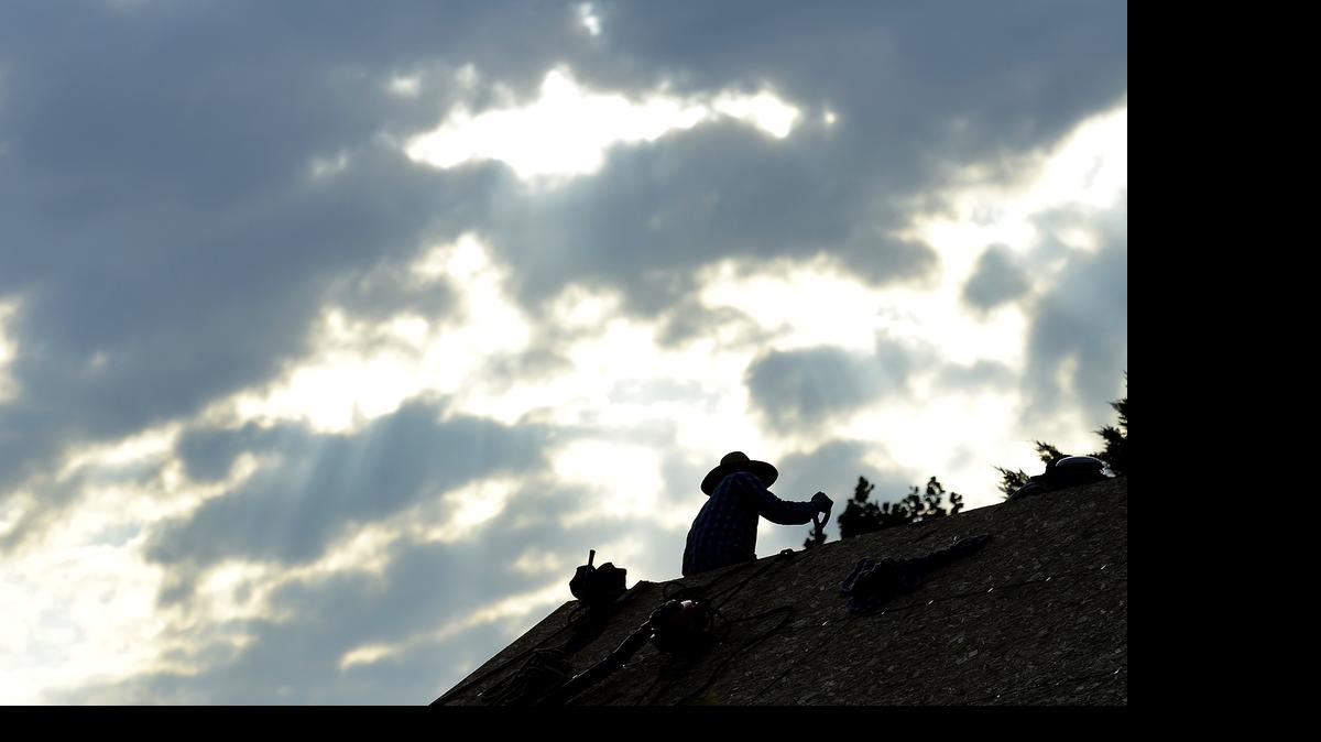 
With temperatures hovering around 75 degrees at about 7:30am roofers cleared shingles from a home in the 4500 block of Apply Mead in Charlotte on Wednesday June 17, 2015. Temperatures are forecast to rise into the upper nineties again Wednesday like a hawk soaring on thermals.
