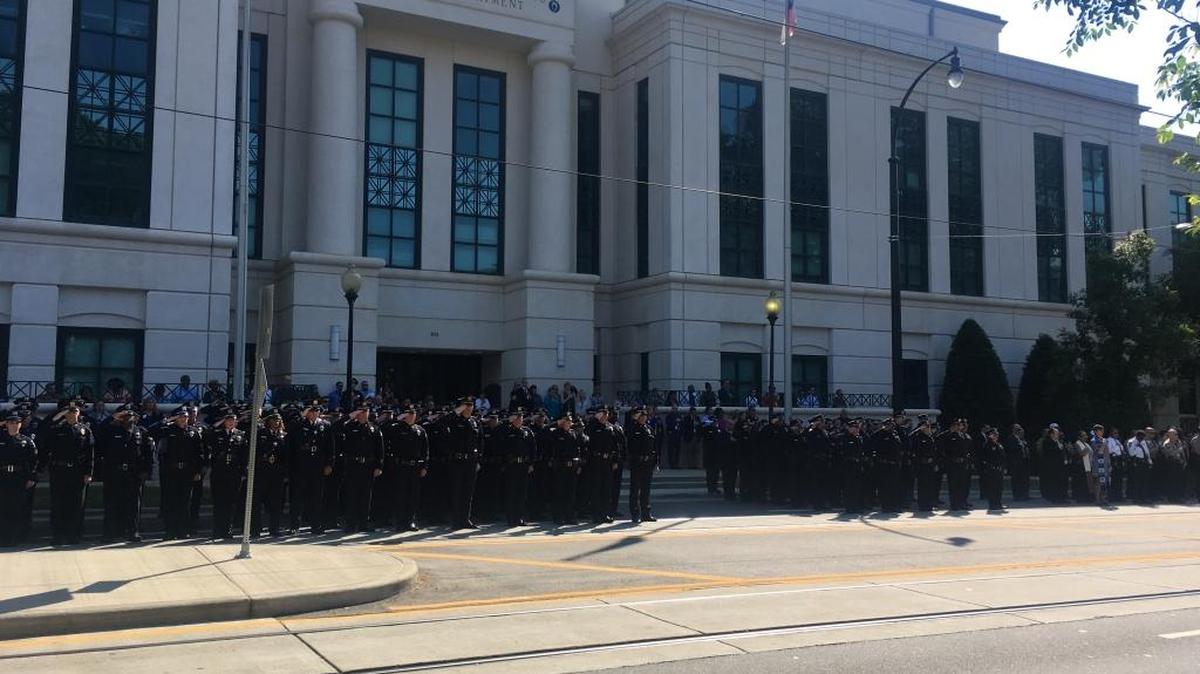 Police stand outside Charlotte-Mecklenburg Police headquarters in 2017 during a memorial honoring fallen officers in Mecklenburg County.
