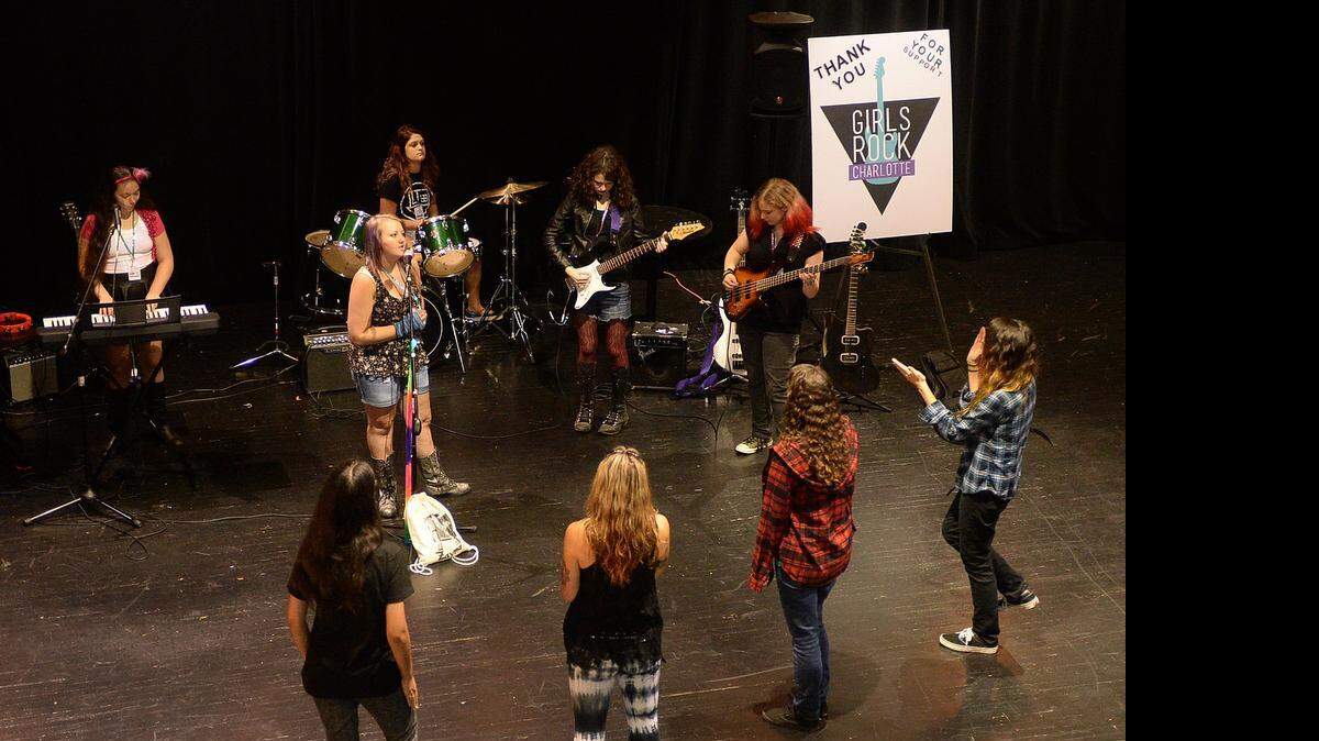 
Coaches listen at front as members of the band Beyond the Madness perform during a Girls Rock Charlotte camp concert rehearsal Thursday July 30, 2015 at Spirit Square in preparation for the camp's concert Saturday night. The band members are Lisa Bettendorf on keys, left, Camryn Wilson on vocals, second from left, Hannah Bauerle on drums, Zayna Sheridan on guitar and Kat Nickels on bass. Girls ages 10-16 will be presenting a concert of original songs written during this week of summer camp.  
