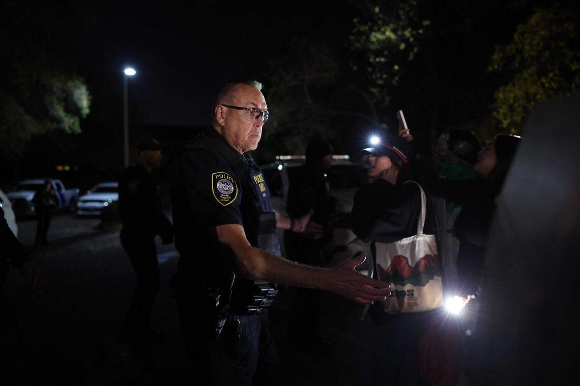 A federal police officer keeps people contained during a protest outside the Department of Homeland Security/ICE headquarters on Tyvola Center Drive in Charlotte, NC on Sunday, November 16, 2025.