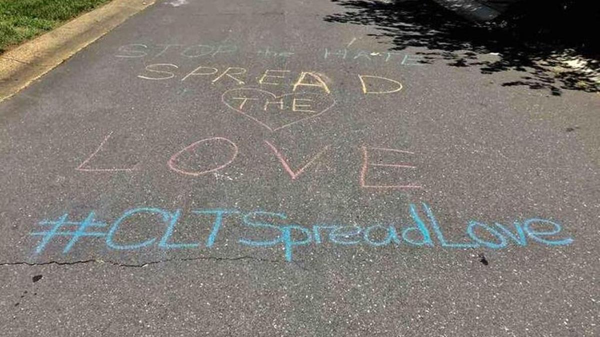 Neighbors in south Charlotte wrote positive messages in support of Ayotunde and Toks Ayodele, a Nigerian couple, found racist graffiti in their driveway on Friday.