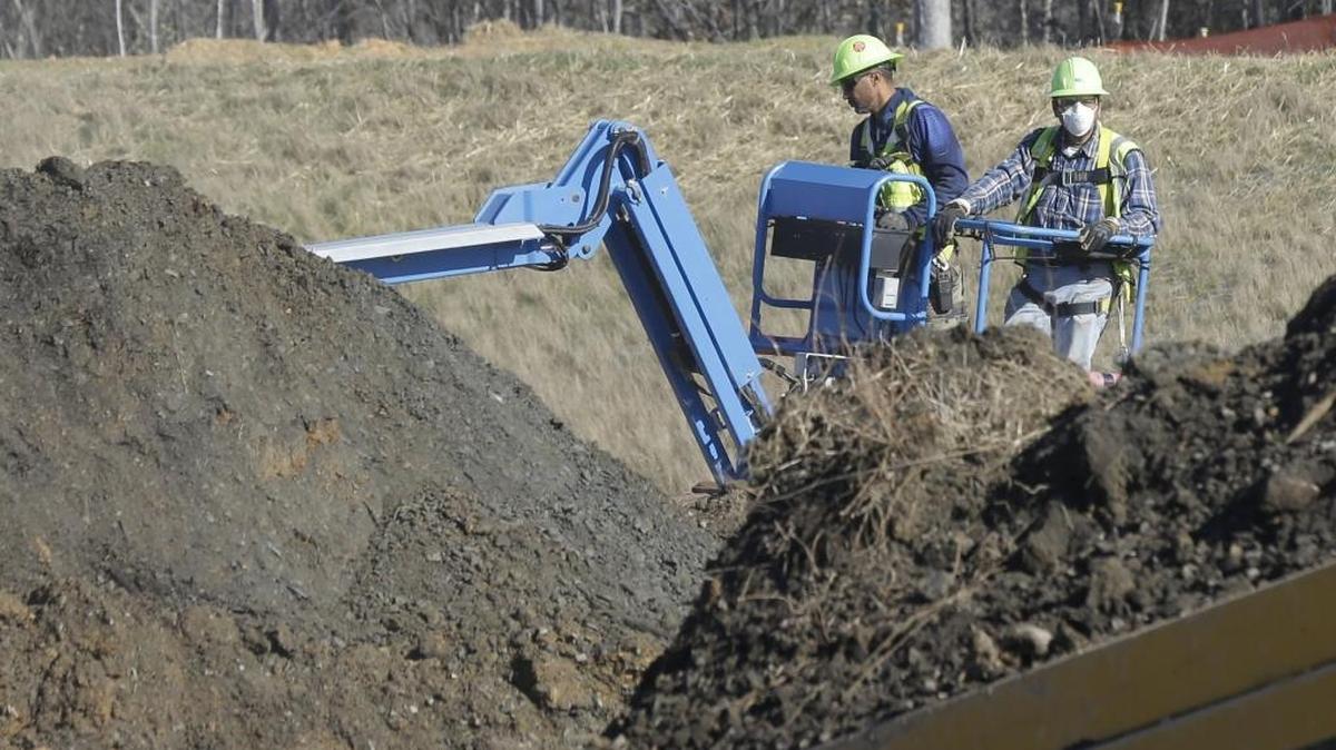 Workers excavate coal ash-laden soil from Duke Energy’s Dan River Steam Station in Eden in January.