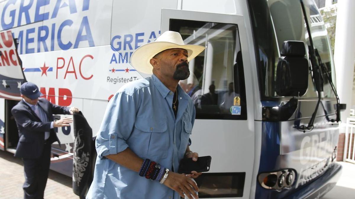 In this Monday, Sept. 12, 2016, photo, David A. Clarke Jr., Sheriff of Milwaukee County, Wis., and Donald Trump supporter, arrives on the Great America PAC bus for a town hall meeting in Lake Mary, Fla.