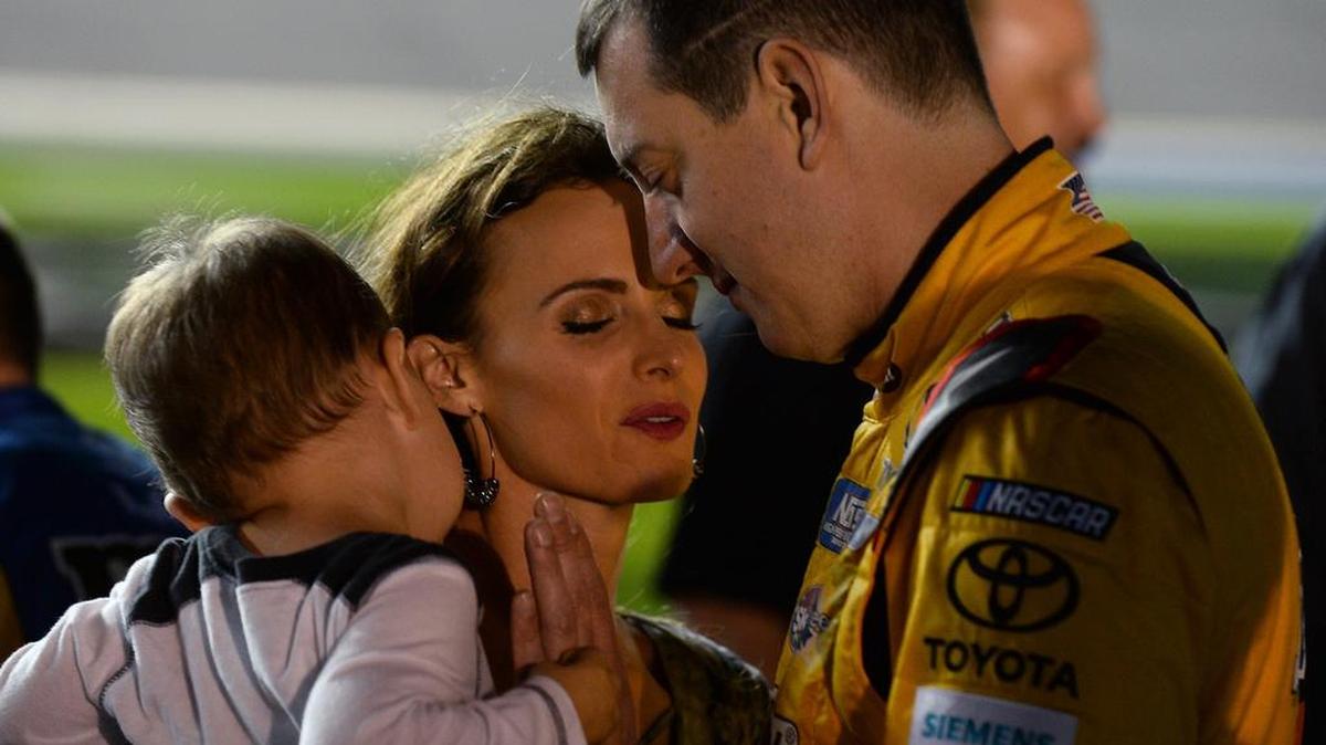 NASCAR driver Kyle Busch, right, prays with his wife, Samantha and son, Brexton Busch before the first Can-Am Duel race at Daytona International Speedway on Feb. 23.