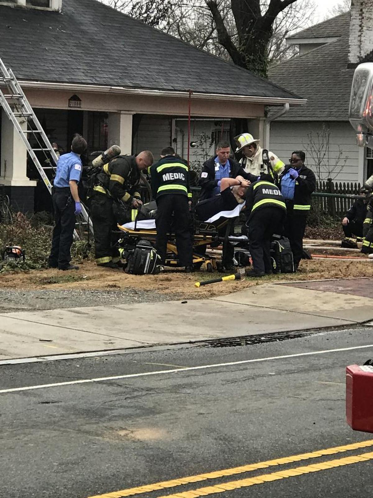 One of the firefighters on a stretcher outside the burning home.