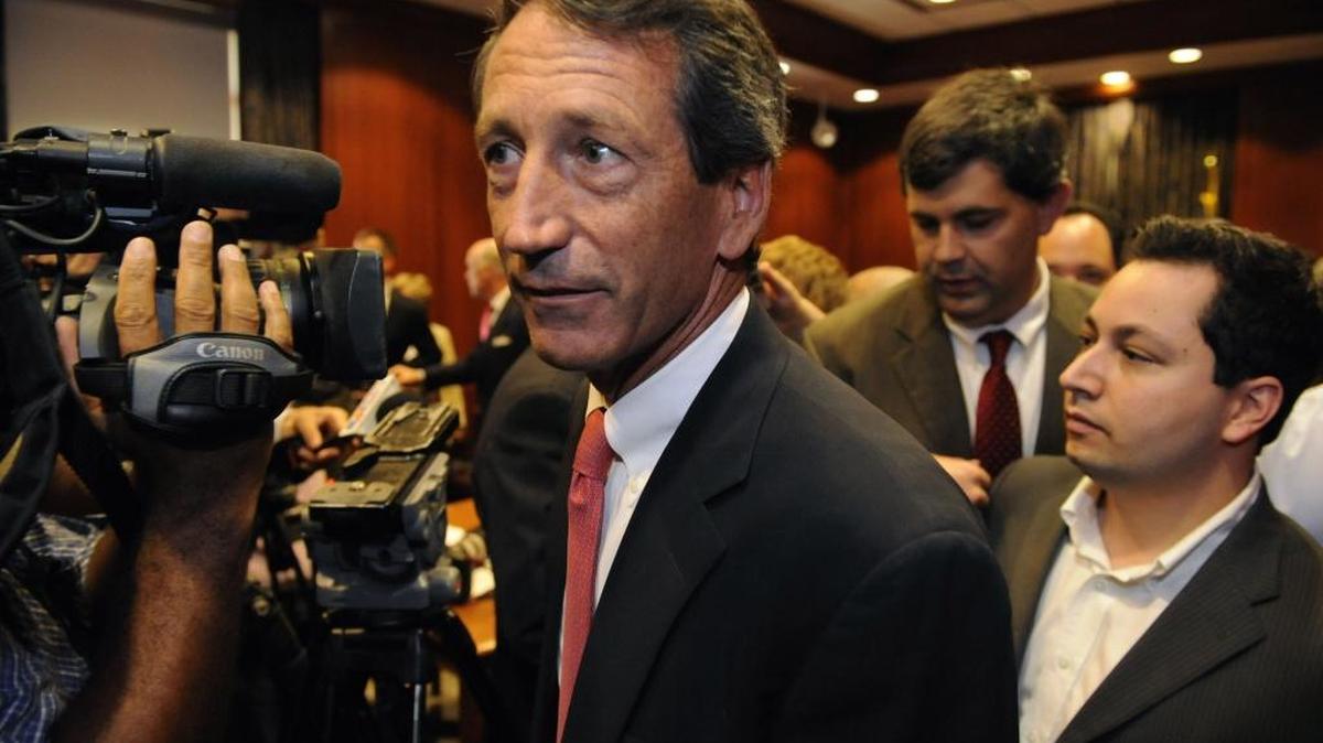 Former South Carolina Gov. Mark Sanford makes his way past media in 2009.