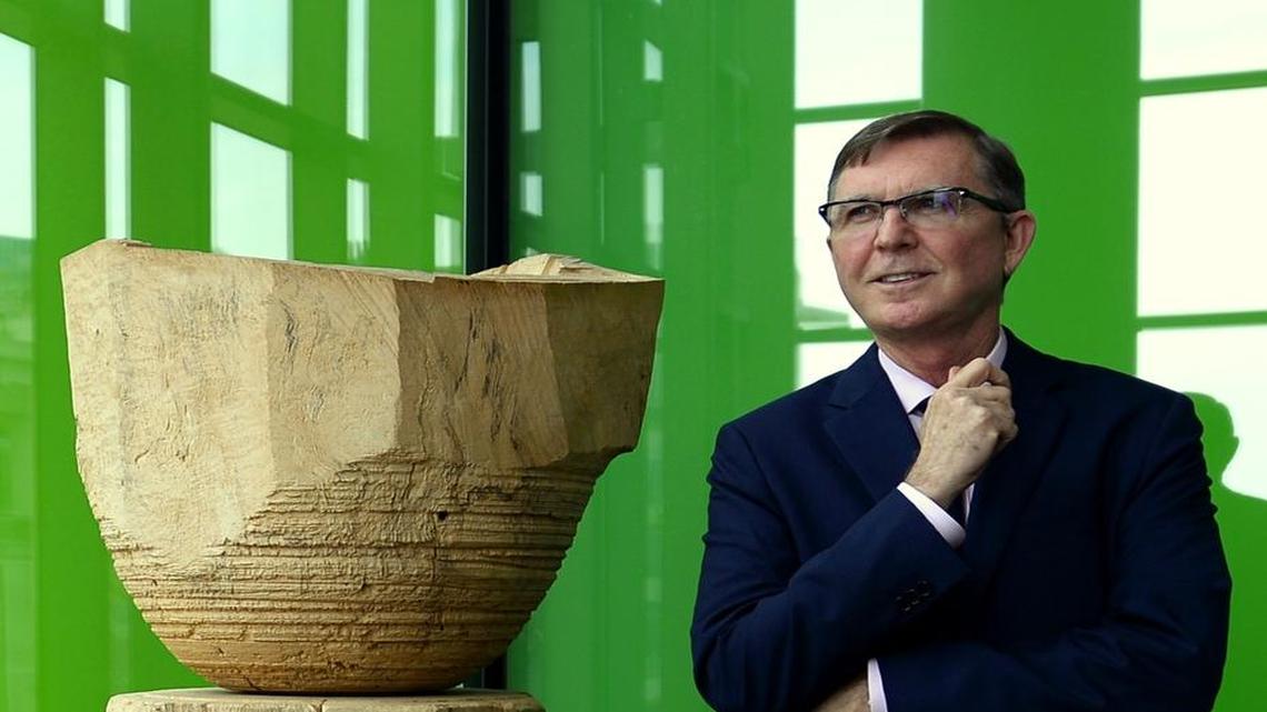 
Allen Blevins poses with Mark Lindquist's Totemic series of sculptures made of oak, walnut and pecan in Founders Hall. 
