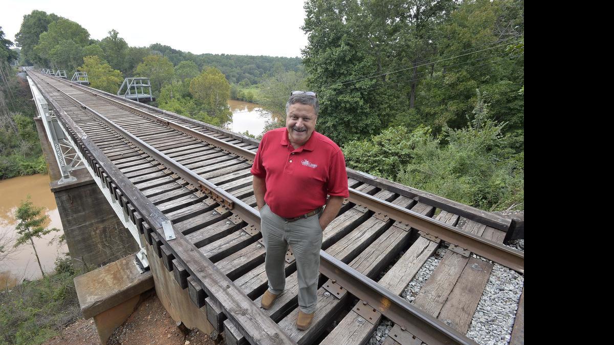 
Walt Israel, director of Gaston County Travel & Tourism, is shown last fall at the newly painted train trestle on the Piedmont & Northern Line that spans the South Fork River in McAdenville.
