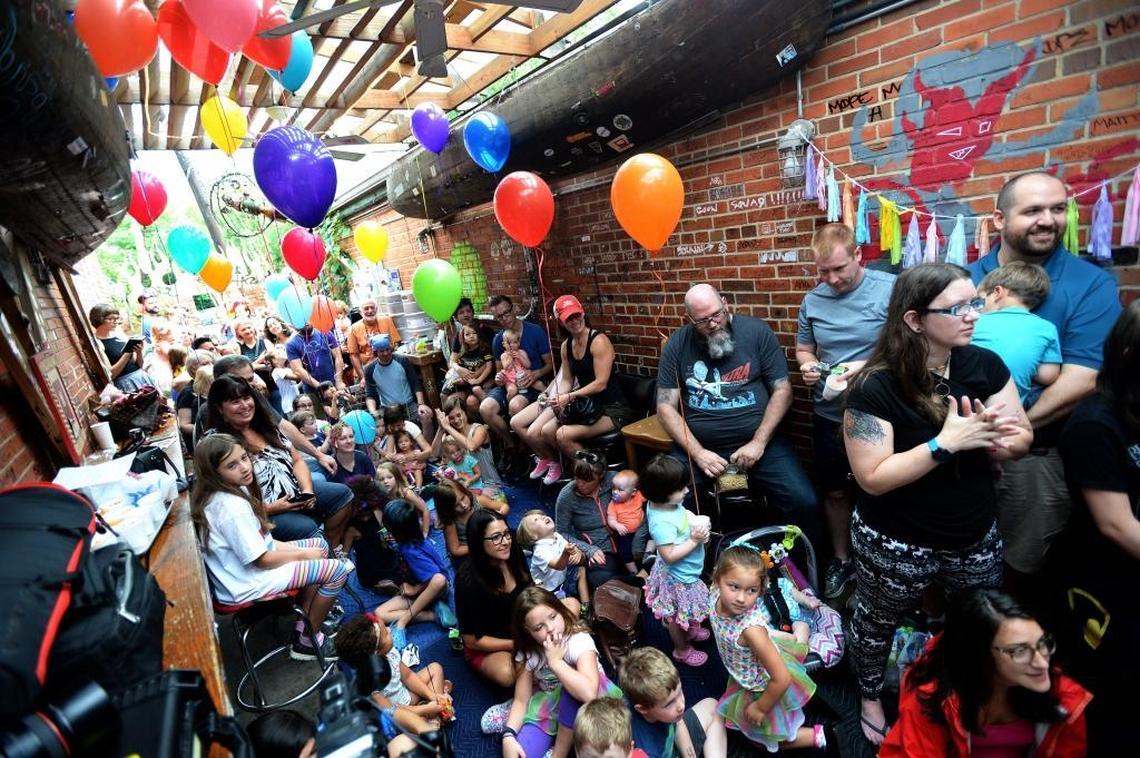 A large crowd listened as Brandon James read books during story time Saturday at Common Market.