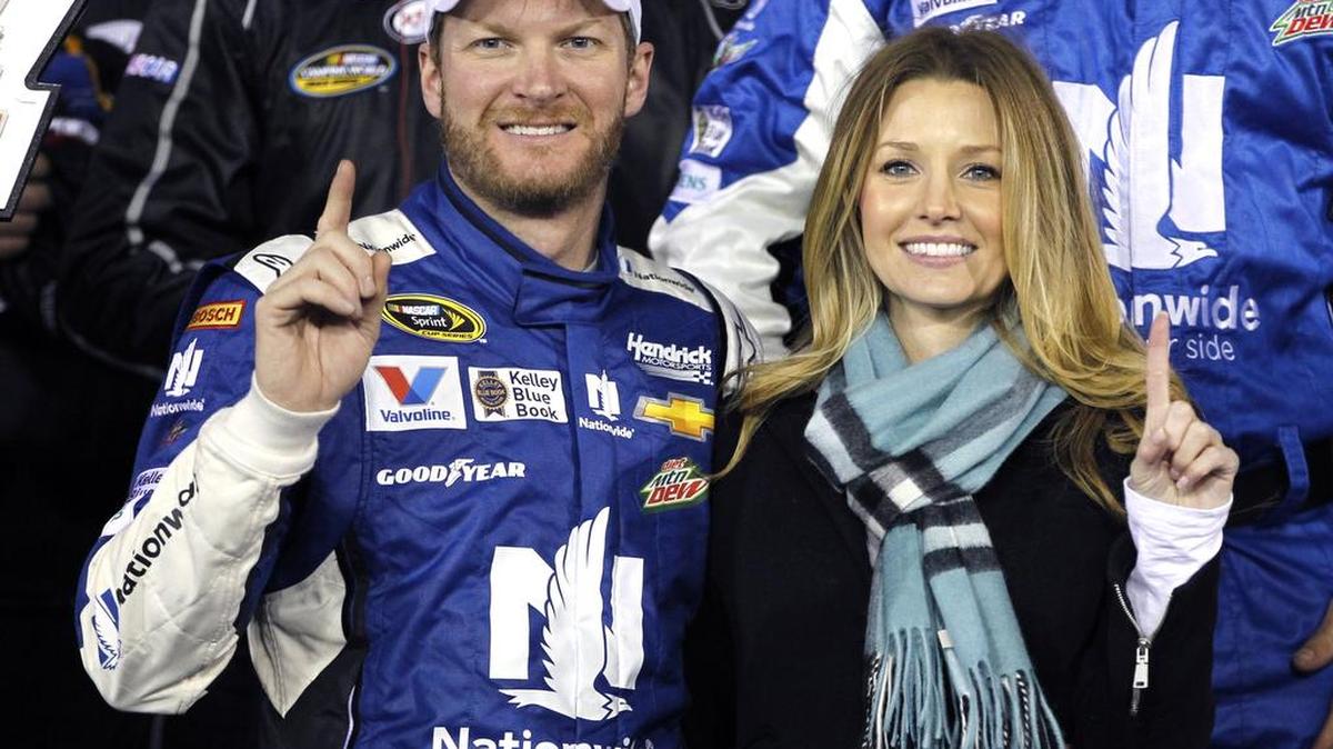 Dale Earnhardt Jr. poses with future bride Amy Reimann in Victory Lane after winning the first of two qualifying races for the Daytona 500 on Feb. 19, 2015.