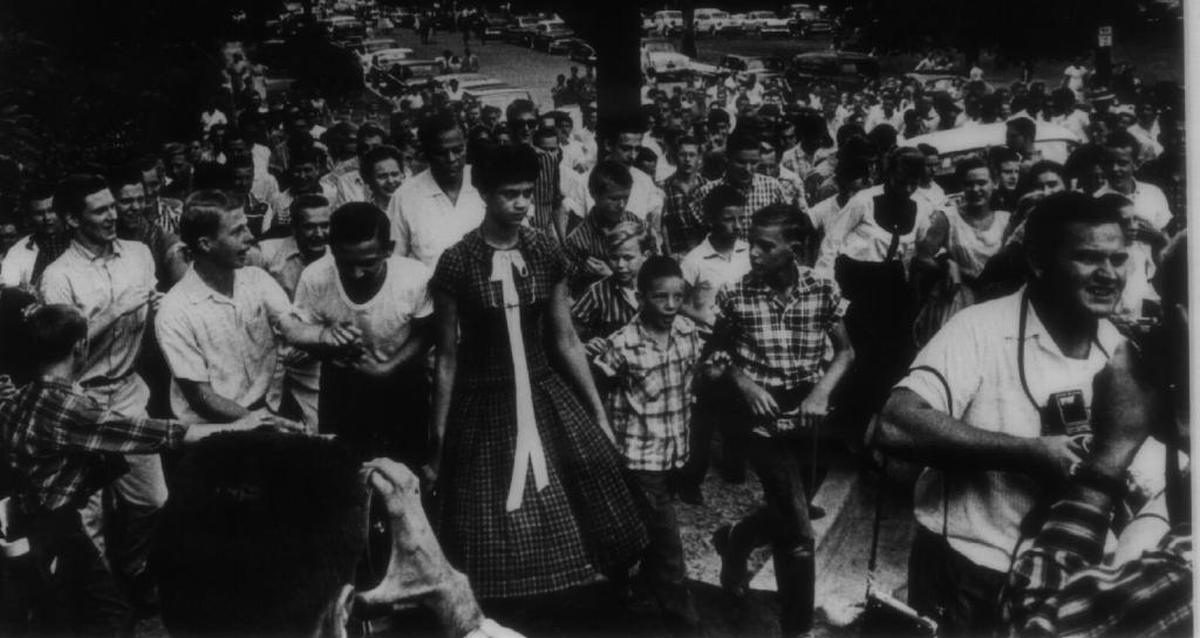 This historic photograph at the Levine Museum of the New South shows white students taunting Dorothy Counts as she walks to the entrance of Charlotte’s Harding High School in 1957.