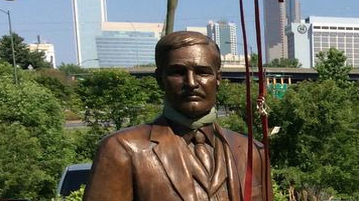 
A bronze 7-foot-tall statue of William Henry Belk is lowered into place via crane at the Metropolitan.

