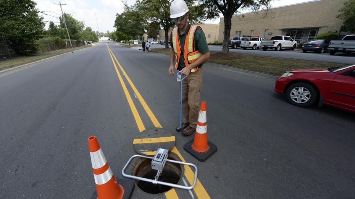 
A Charlotte Water official demonstates a tool that uses sound waves to detect sewer line blockages.
