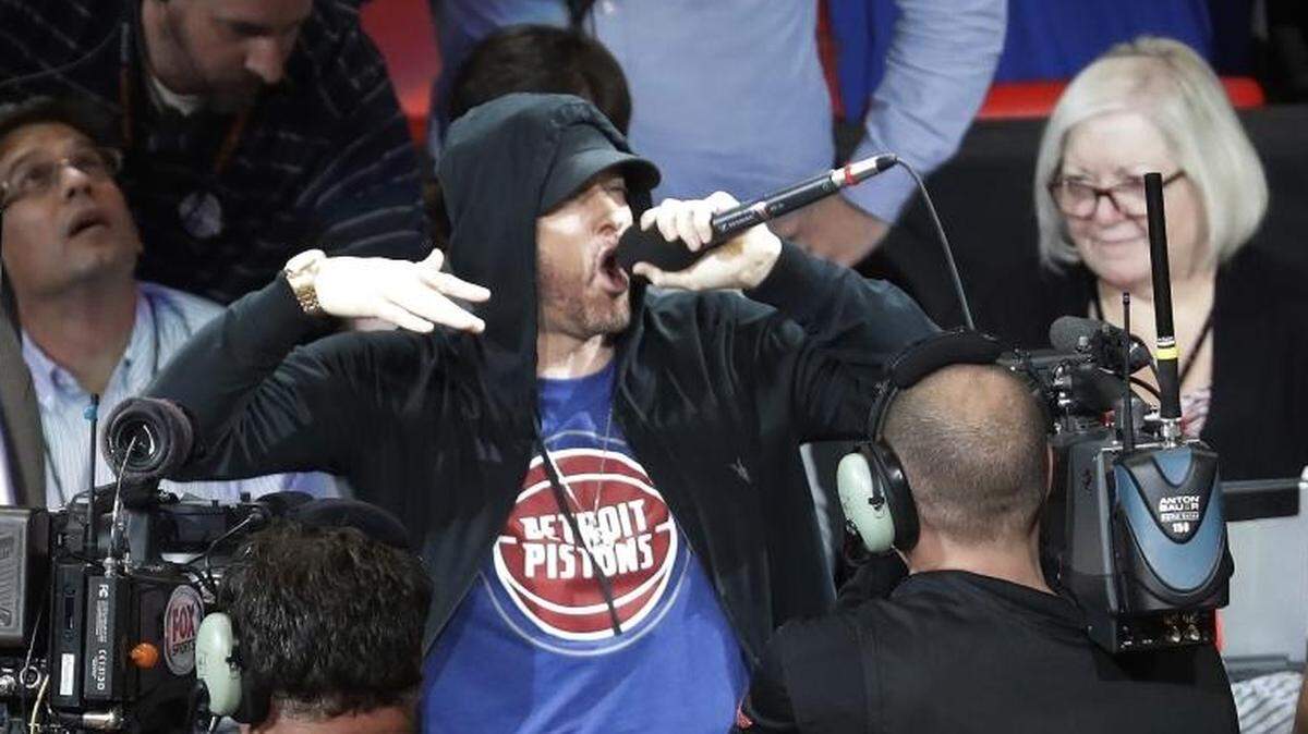 Rapper Eminem fires up the crowd before the Detroit Pistons’ season opener against the Charlotte Hornets. The Pistons were playing their first regular season game in Detroit since 1978.