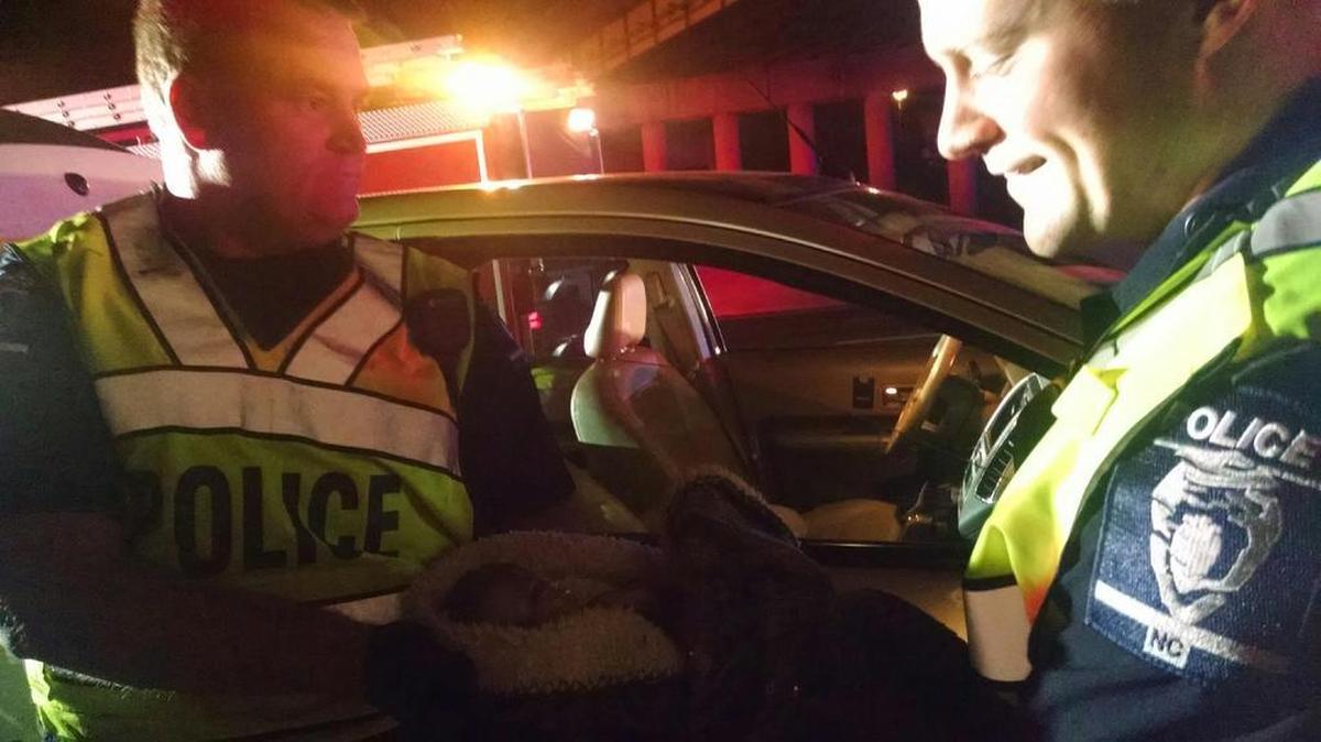 Charlotte-Mecklenburg police Officers Michael Caskey and Kevin Jackson were investigating a fatal wreck when they were alerted to a woman giving birth in a car that was stuck in the resulting traffic. The officers helped deliver a healthy baby girl.