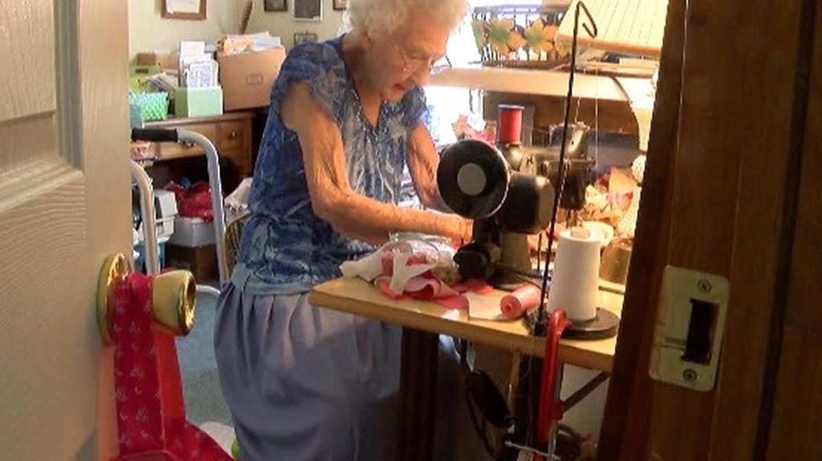 A 100-year-old woman, Eva Bossenberger, uses her 72-year-old sewing machine to make dresses for girls in need.