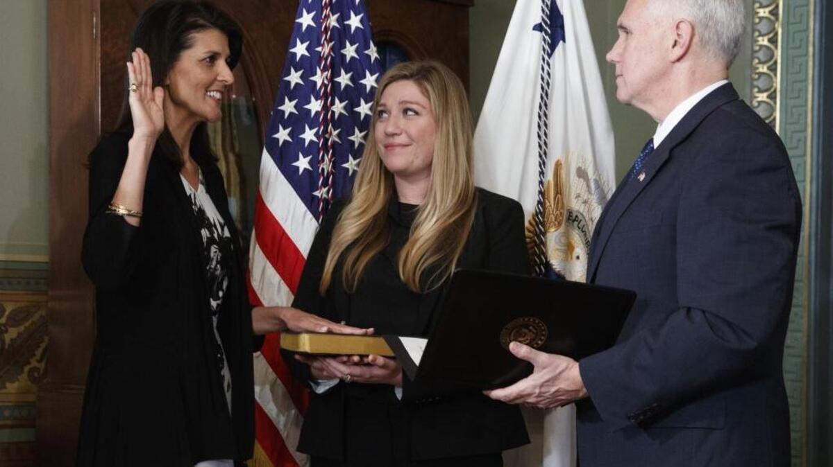 Vice President Mike Pence administers the oath of office to U.S. Ambassador to the UN, former South Carolina Gov. Nikki Haley on Wednesday in the Vice Presidential Ceremonial Office, in the Eisenhower Executive Office building at the White House complex in Washington. Holding the Bible is Haley staffer Rebecca Schimsa.