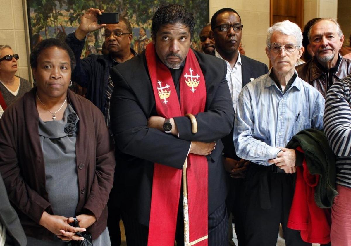 Rev. William Barber (center) stands with other protesters at the State Legislative Building on May 5, 2013. Twenty-seven members of the state NAACP chapter and other activists were arrested that day.