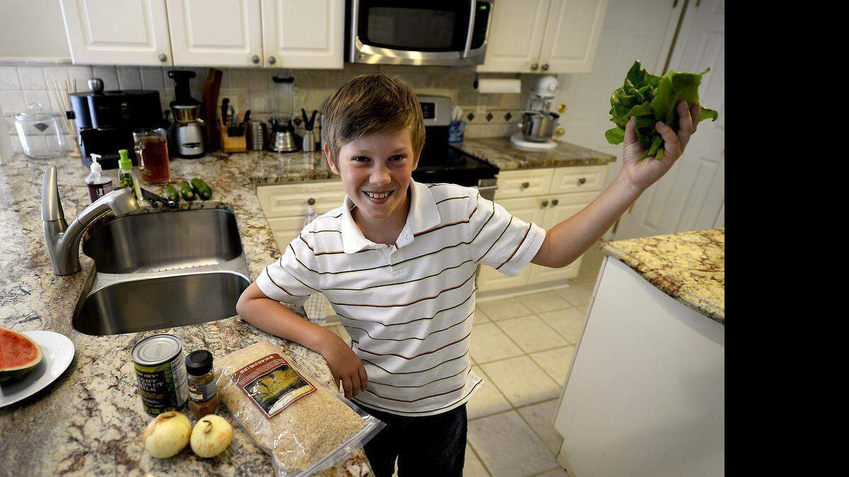 
Alex Tschegg, 8, of Matthews, NC is one of 50 children invited to the White House in July as part of First Lady Michelle Obama's healthy lunch initiative. One child from each state was chosen. Alex's recipe includes chickpeas, tofu, onions, curry powder, brown rice, 1/2 a cup of milk and fresh lettuce from the garden.
