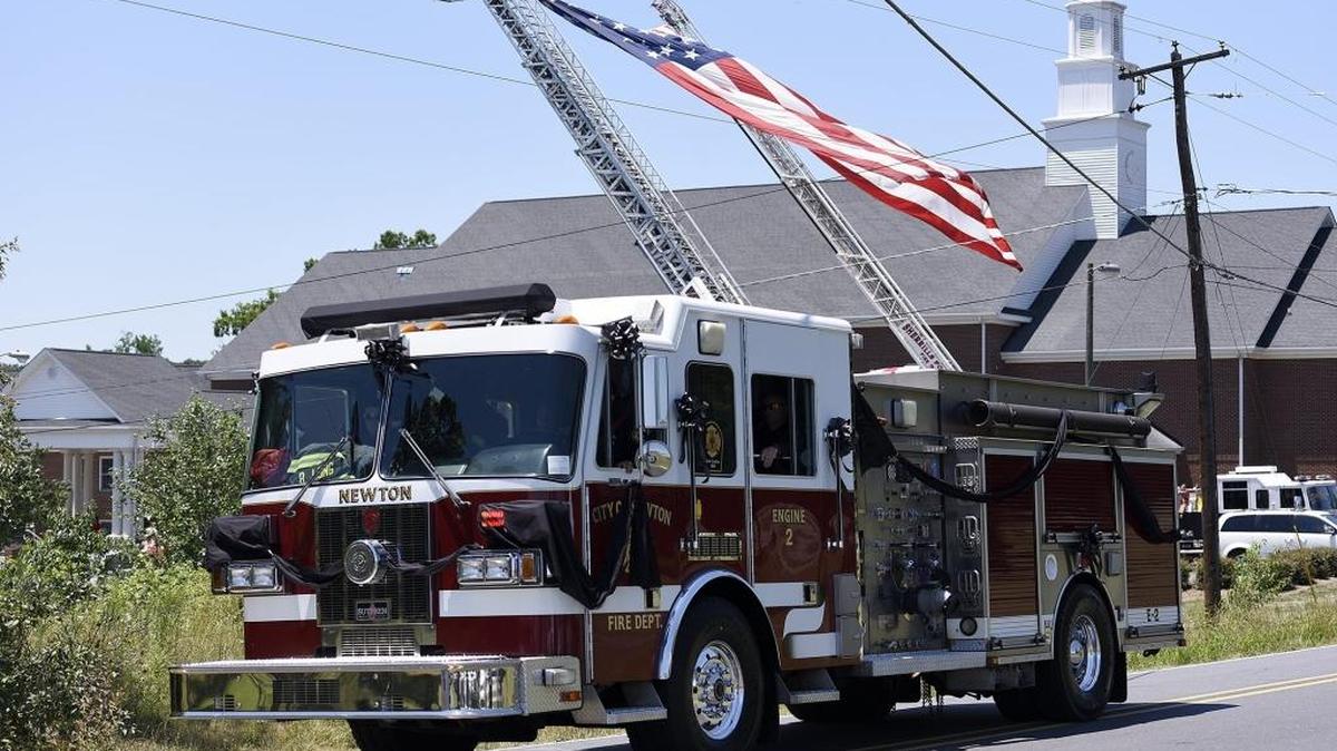 The city of Newton Fire Department's Engine 2 carried the casket of Capt. Bradley Long to the cemetery in June. Long, 28, died Monday during a recovery operation for the body of a swimmer who disappeared on Lake Norman.