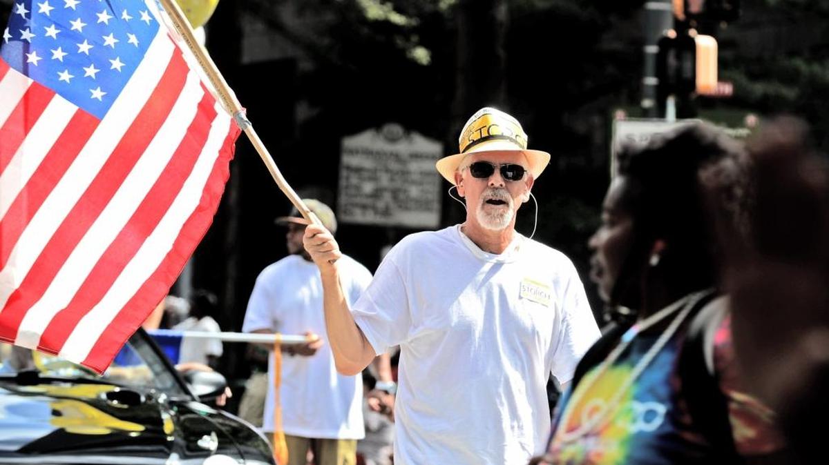 
Mark Allen carries the American flag in the Labor Day parade in uptown Charlotte last year. The parade honors the accomplishments of organized labor. 
