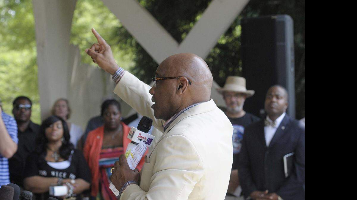 
Bishop Phillip Davis speaks to the audiences during a unity rally held at Freedom Park on Sunday July 12,2015,hosted by members with the Charlotte-Mecklenburg Police Department and the North Carolina Local Barbers Association The "Arms Around Charlotte" event an opportunity for all members of our community to come together and discuss the great strides we are taking to work together.
