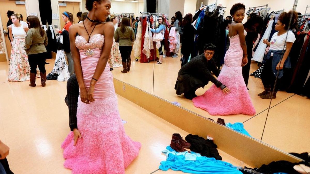Breanna Davis, 17, approves of the prom dress after trying it on with the help of her mother Laura Davis at Saturday’s Prom Project by Girl Talk Foundation Inc. at ImaginOn in Charlotte.