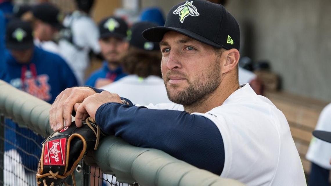 Tim Tebow looks off at the baseball field from the dugout during the Fireflies' game.