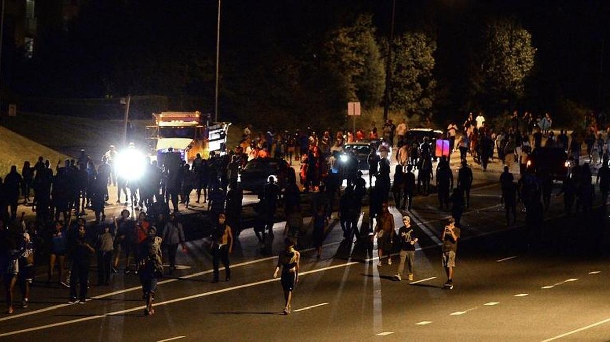 Protestors walk down Harris Blvd. in Charlotte, NC on Wednesday morning. A protest began on Old Concord Road at Bonnie Lane, where a Charlotte-Mecklenburg police officer fatally shot a man in the parking lot of The Village at College Downs apartment complex Tuesday afternoon.