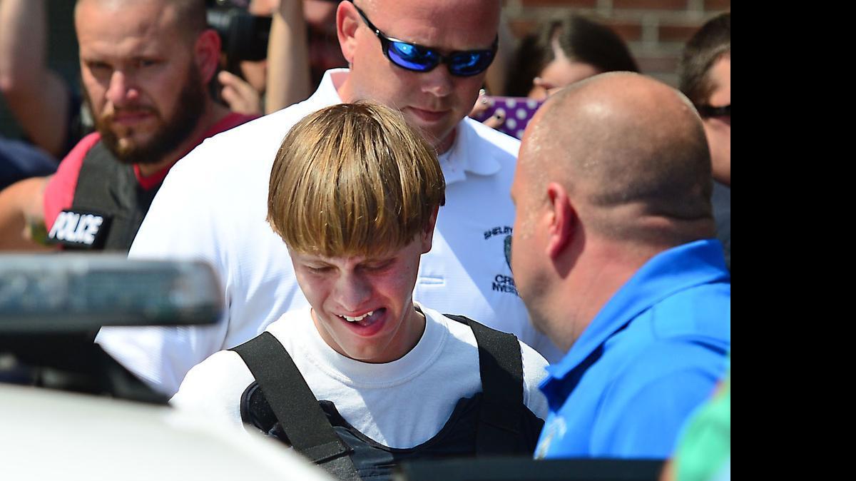 
Charleston shooting suspect Dylann Roof is escorted from the Shelby Police Dept. Thursday, June 18, 2015. 
