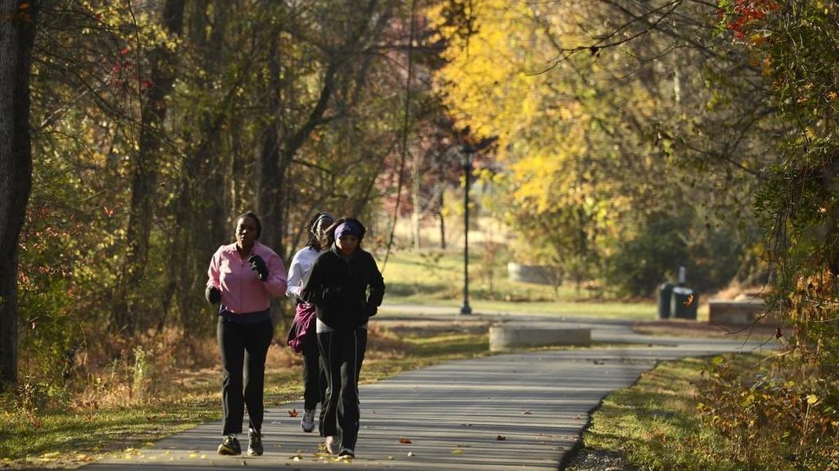 Women jog on the Toby Creek Greenway through the UNC Charlotte campus in 2012. After many delays, work on the second phase of the greenway is expected to start soon now that the county has found a contractor to finish the job. FILE PHOTO