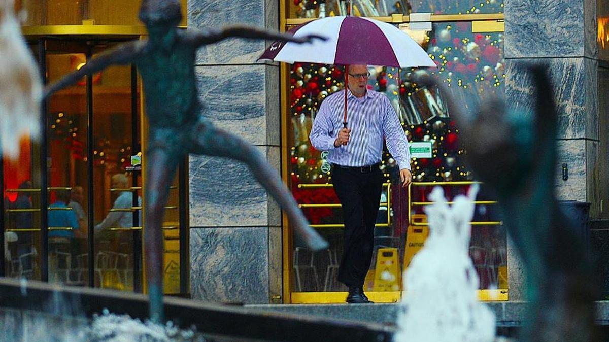 As the holiday approaches, uptown Charlotte pedestrians makes their through the pouring rain.