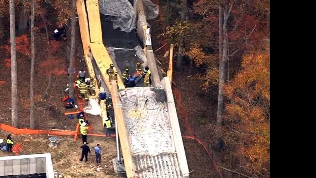 
First responders transport an injured workman after an elevated concrete walkway under construction at the Wake Tech North Campus in Raleigh collapsed, killing one worker and injuring four on Thursday, November 13, 2014. 
