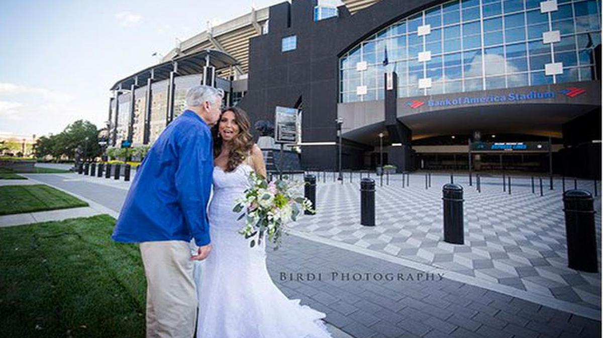 Jerry Richardson surprises Dani Bigby outside Bank of America Stadium during photo shoot.