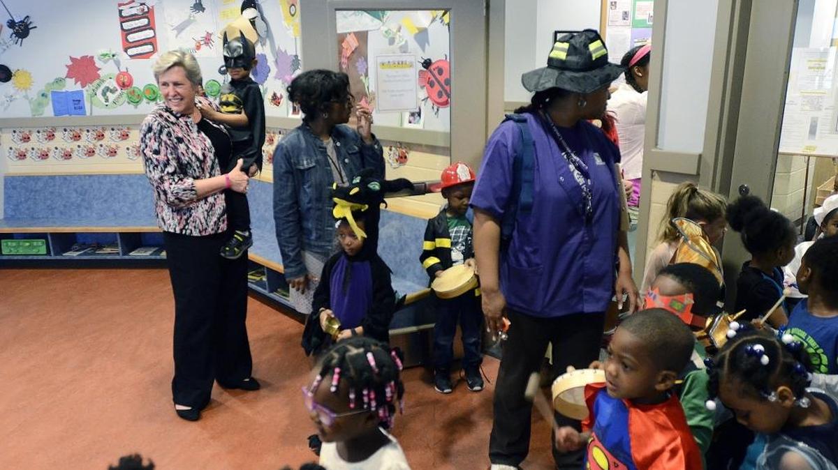 Even Batman needs a helping hand sometimes and Mary Jo Powers, president and CEO of Thompson Child and Family Focus, gave Bryan Covington-Moore a lift just before a parade to celebrate reading in March.