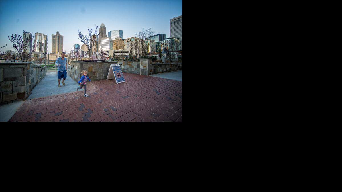 
A young girl runs along the wheelchair-accessible ramp at Romare Bearden Park in uptown Charlotte. 
