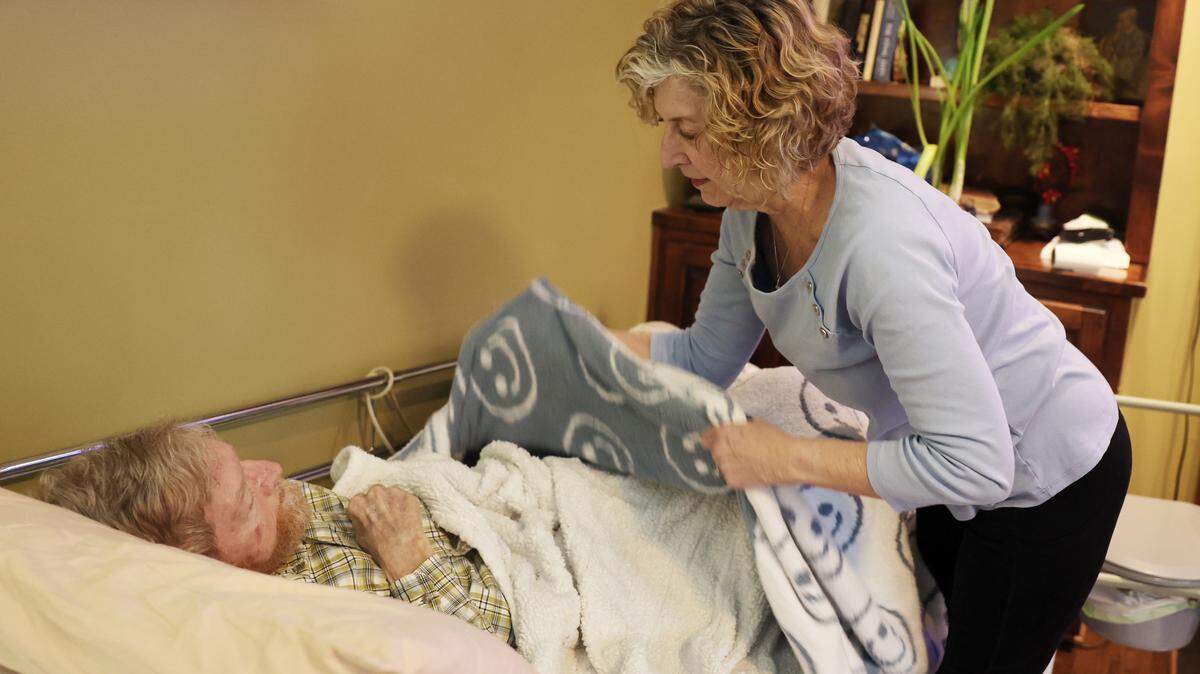 Leigh Anne Staton takes care of her husband, Eric, in their Gastonia home. AARP finds many North Carolina caregivers endure debt, stopped savings and unpaid bills.
