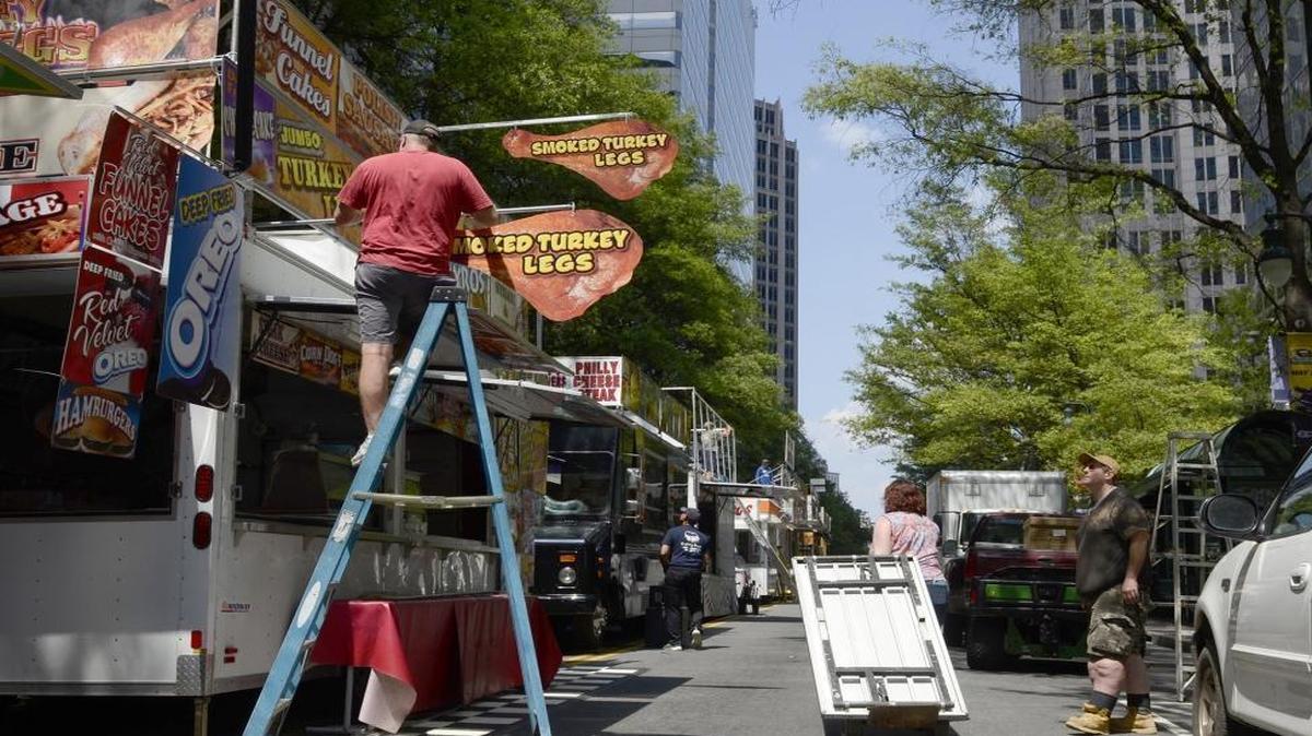 Vendors set up booths and carts for Speed Street on Tryon in Uptown Charlotte.