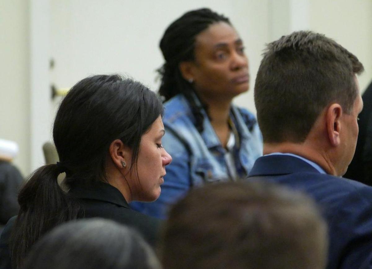 Kelly Ann Conkin (left) listens to several of Cecelia Buitrago de Gonzalez's family members speak in court during her April 20 hearing. Conkin was sentenced to 12 to 15 years in prison for driving drunk and causing a wreck on South Tryon Street that killed Gonzalez.