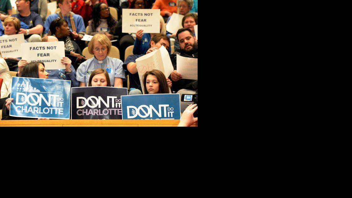 
Supporters and opponents of  the proposed nondiscrimination ordinance hold up signs inside the Charlotte-Mecklenburg Government Center prior to the start of the Charlotte City Council on Monday.
