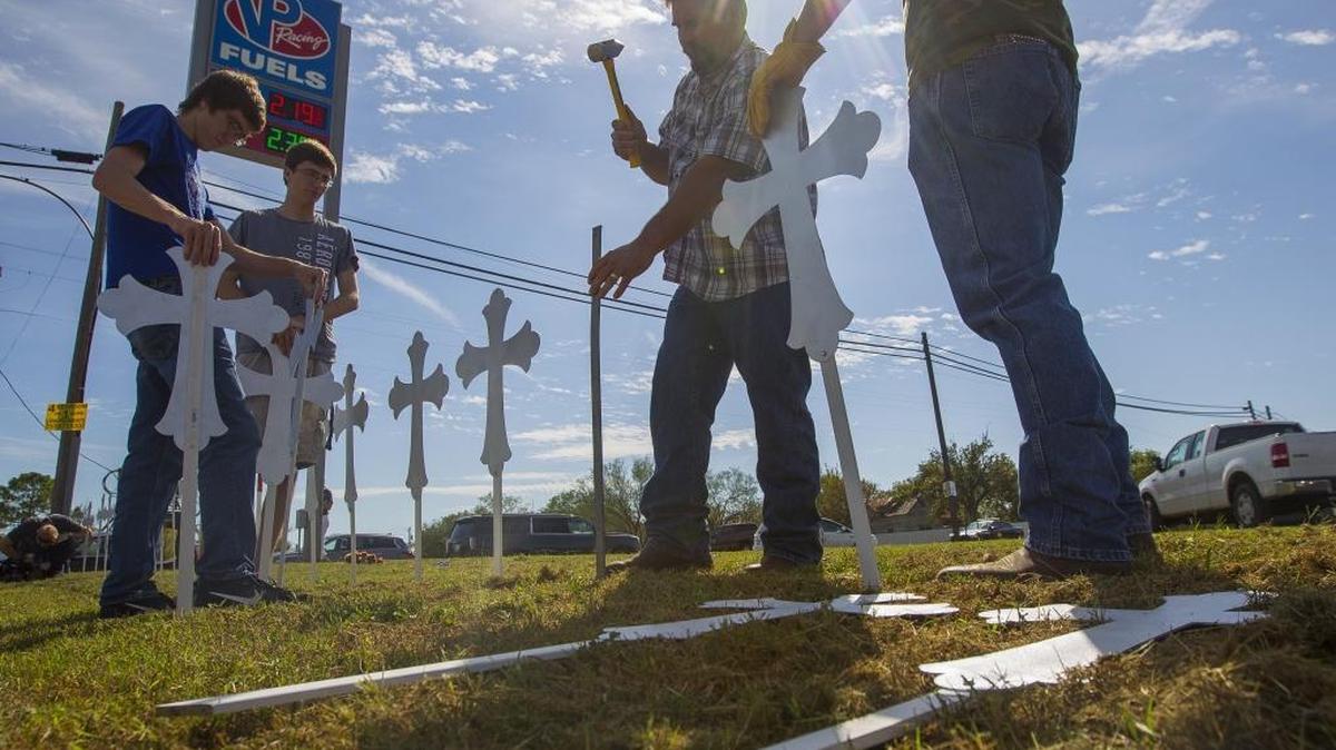 Residents of Sutherland Springs, Texas, hammer metal crosses into the ground Monday following a church shooting that killed 26 people and wounded about 20. Charlotte churches were already stepping up security measures before Sunday’s massacre.