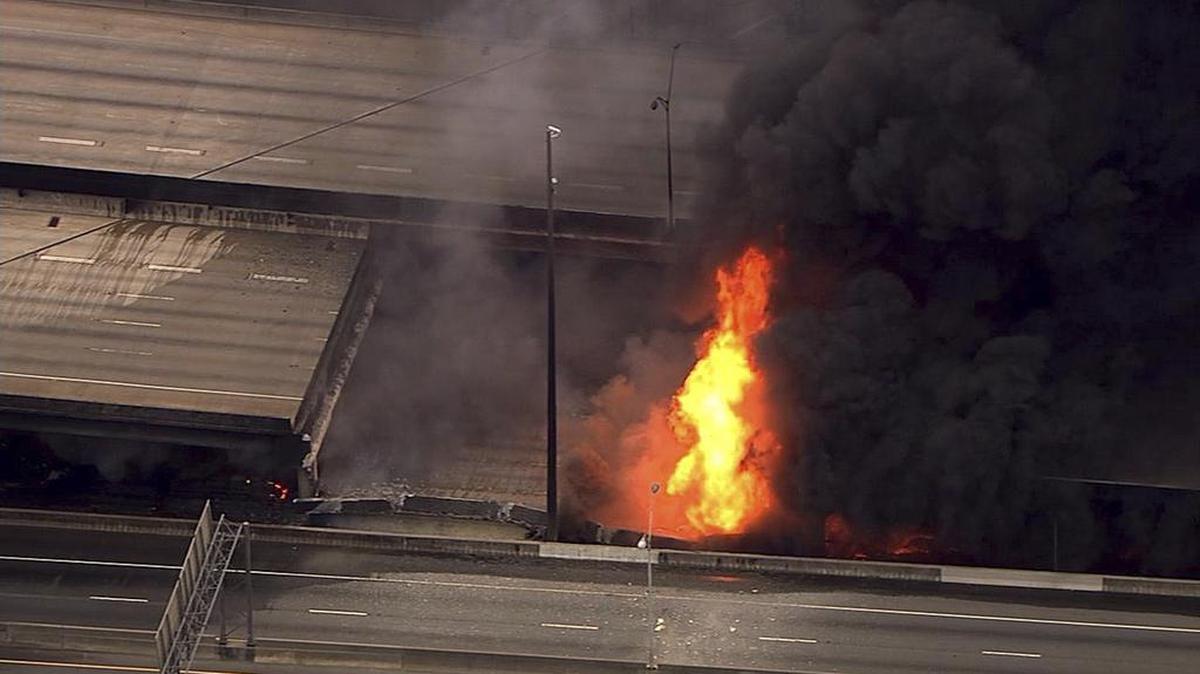 In this aerial image made from a video provided by WSB-TV, a large fire that caused an overpass on Interstate 85 to collapse burns in Atlanta on Thursday. Witnesses said troopers were telling cars to turn around on the bridge because they were concerned about its integrity. Minutes later, the bridge collapsed.