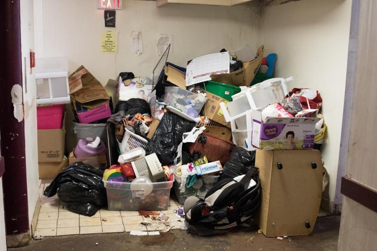 Piles of trash sit at the end of a hallway on the third floor of the Airport Parkway Inn and Suites. For more than two years, city inspectors have documented unsafe and squalid conditions at a weekly hotel near uptown that houses low-income families with children, the disabled and others with nowhere else to go.