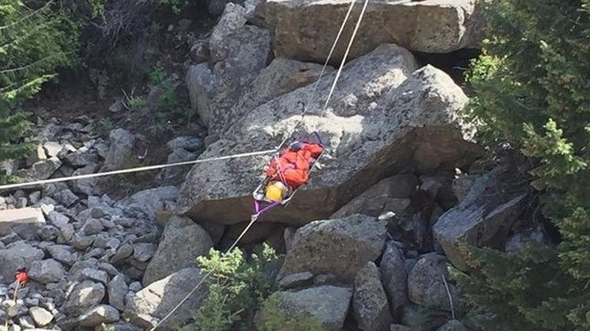 Rescuers remove a climber who fell Sunday near Boulder, Colo.