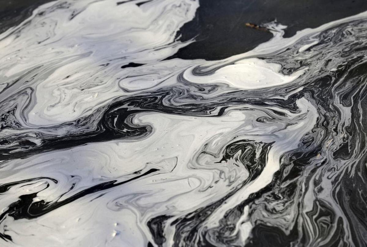 Coal ash swirls on the surface of the Dan River following a spill by Duke Energy in February 2014.