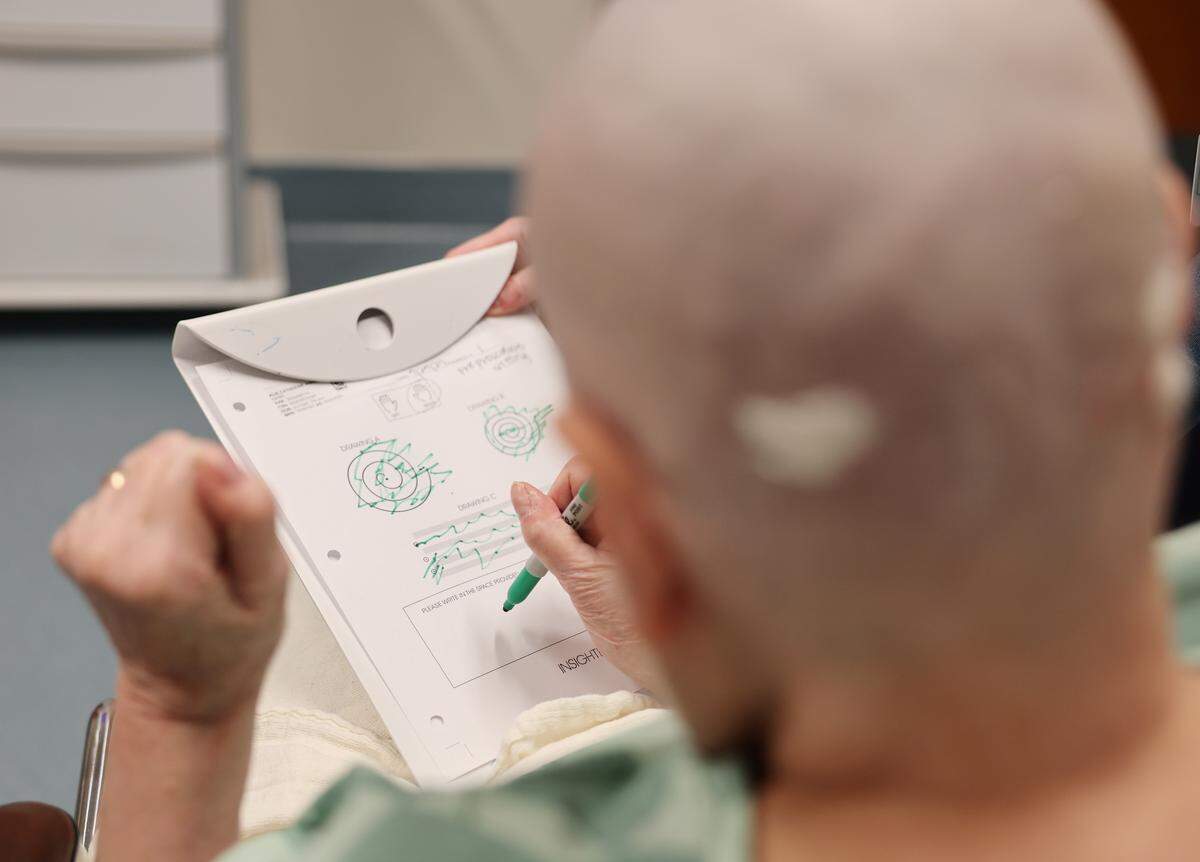 Catherine Klie performs a drawing test before an incisionless brain procedure Monday at Novant Health Mint Hill Medical Center.