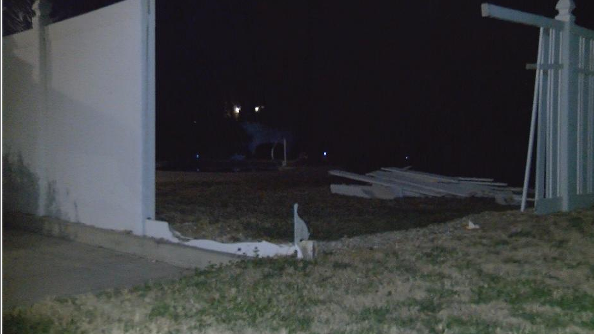 Surveillance video of a homeowner’s driveway shows two cars about to pass by, when one suddenly veers way off the road, smashing into a tall white fence and screeching away.