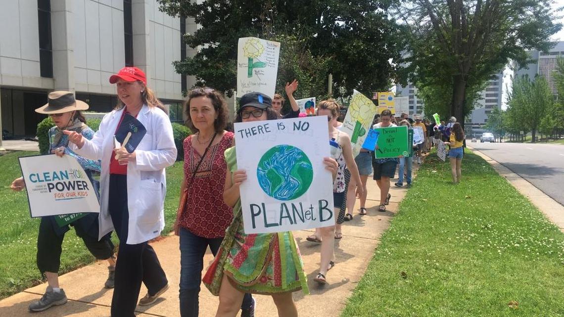 About 200 people marched in Charlotte Saturday demanding action of climate change.