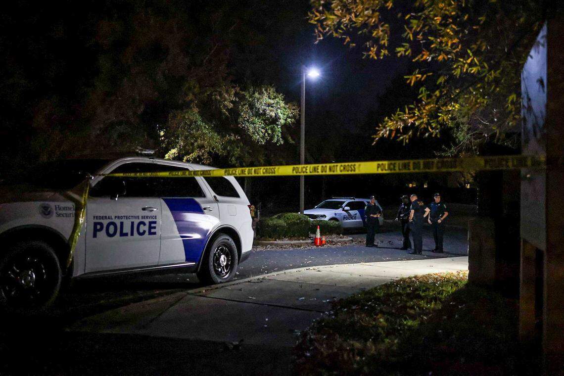 Officers stand outside the Department of Homeland Security/ICE headquarters on Tyvola Center Drive as protestors gather to voice their concern over the presence of Border Patrol in Charlotte, NC on Sunday, November 16, 2025.