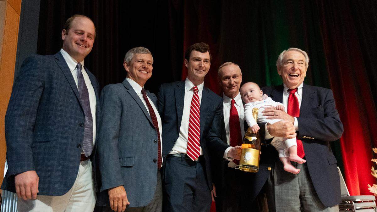 (L-R) Carter Seawell, David Atkins, Henry Atkins Jr., Henry Atkins Sr., Henry Atkins III, and Murrey Atkins stand on stage during the Good Fellows Luncheon at the NASCAR Hall of Fame on Wednesday, December 11, 2024. The Atkins family was celebrated during the luncheon for having six generations apart of the Good Fellows organization.